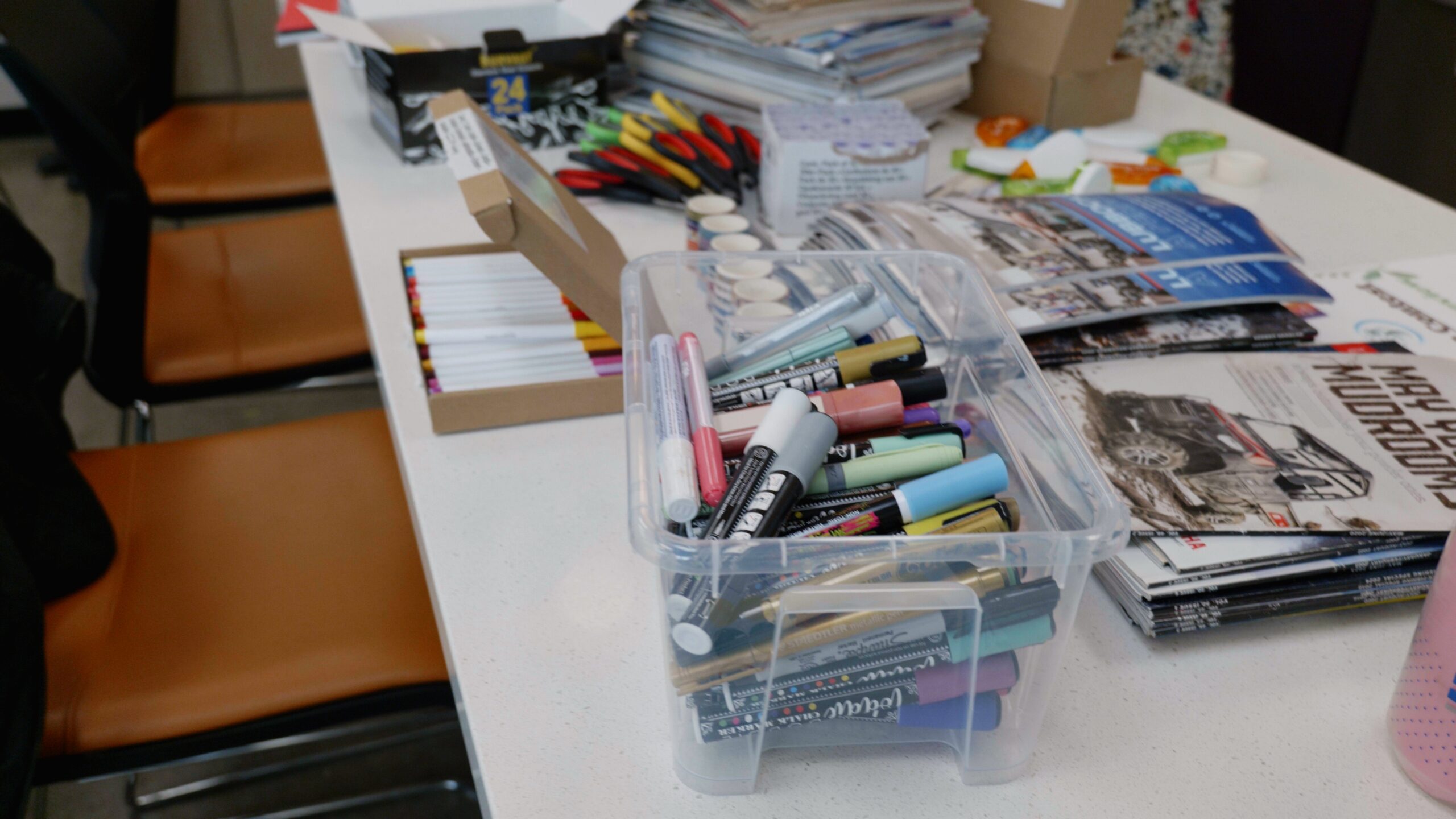Miscellaneous craft supplies spread out on a white table.