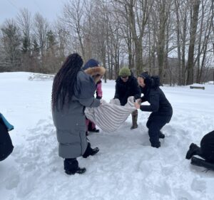 Small group of children/youth playing in snow.