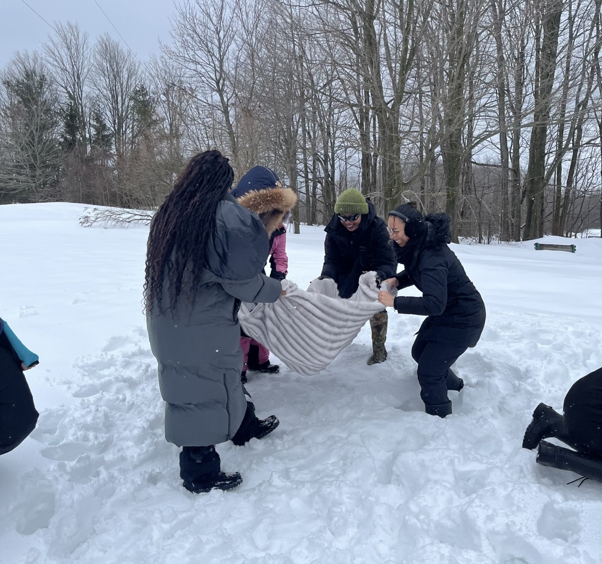 Small group of children/youth playing in snow.