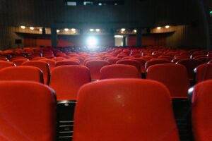 Close up of vacant red seats in a movie theatre.