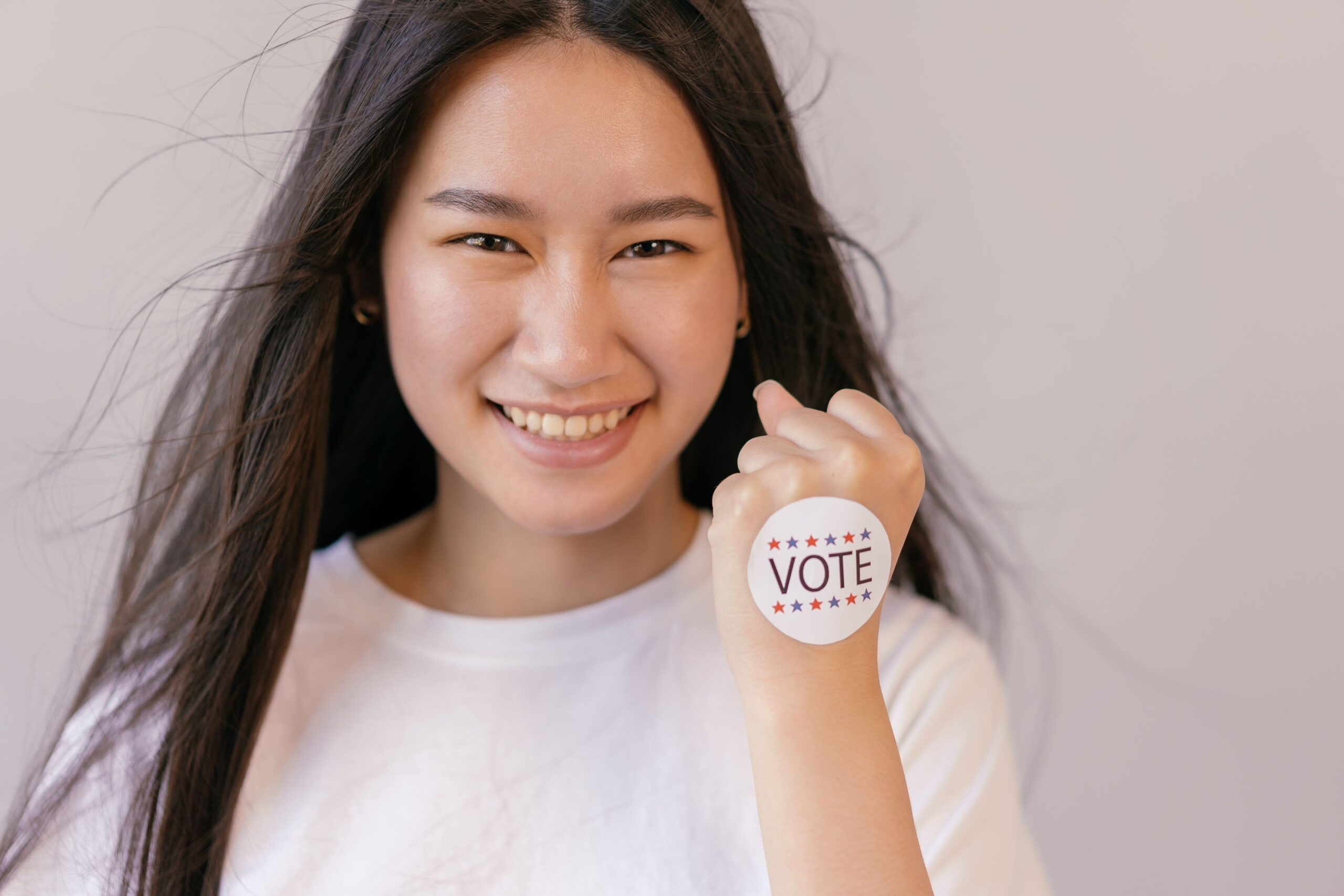 Female youth holding up hand with a 